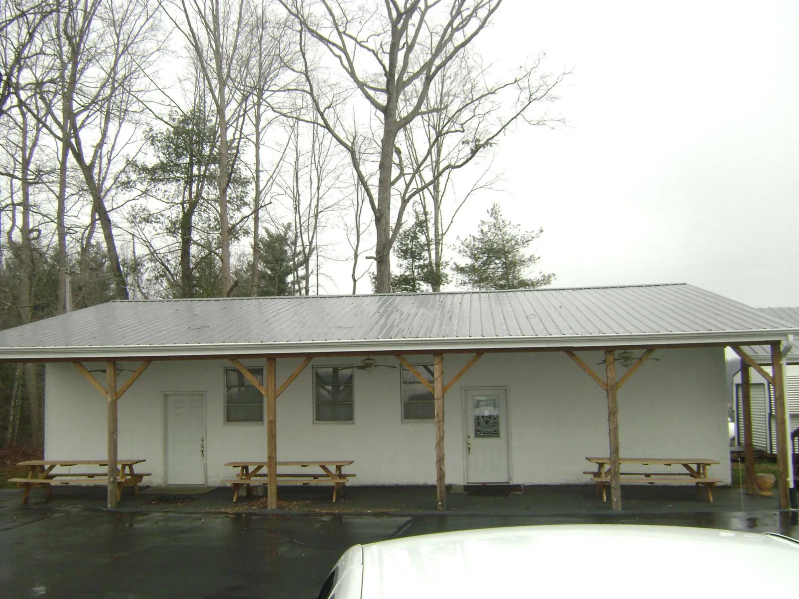 Gray metal roof over a block building with a timber post porch in Fort Morgan